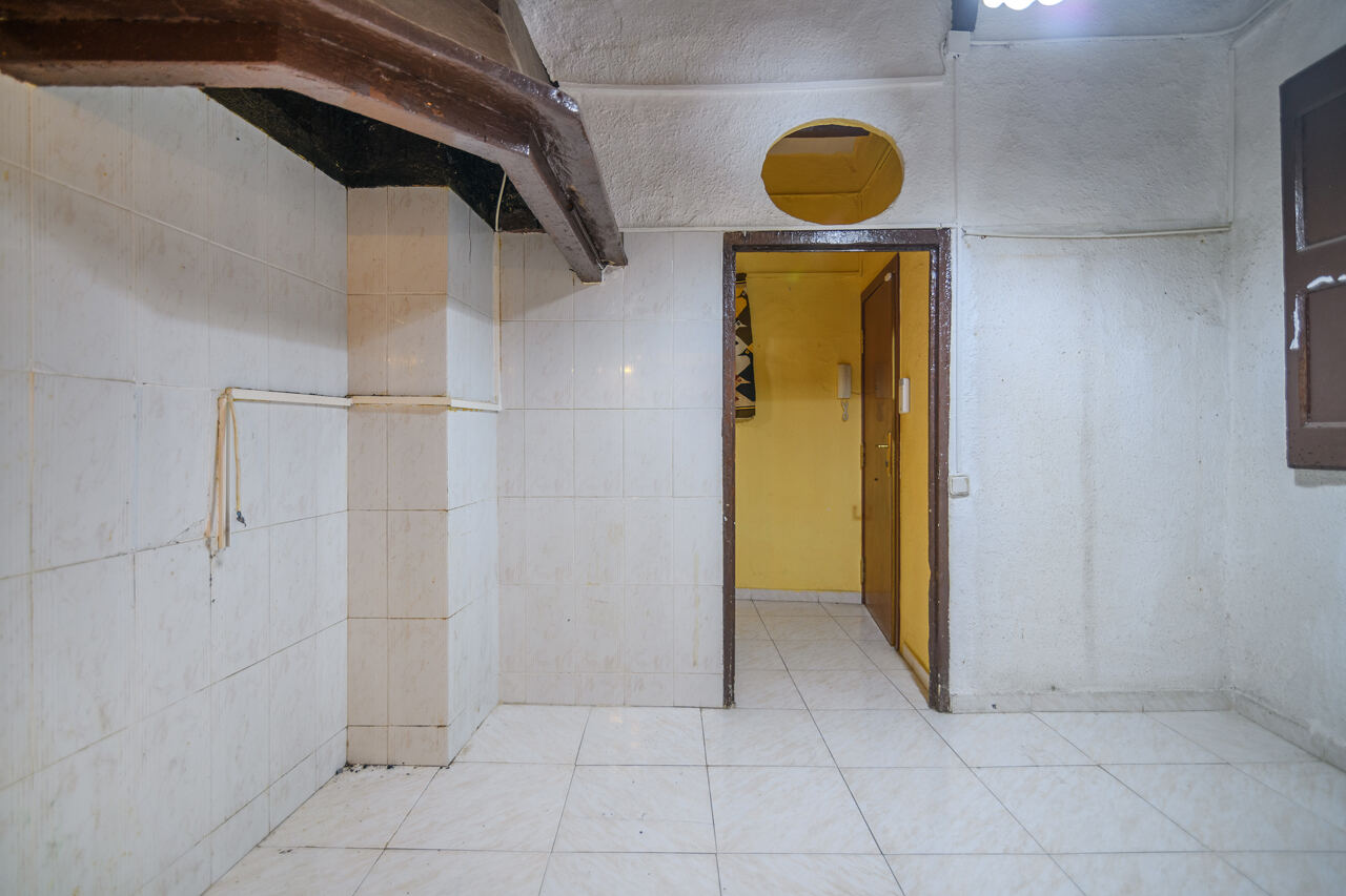 Bathroom area before renovation — tiled walls, dated finishes